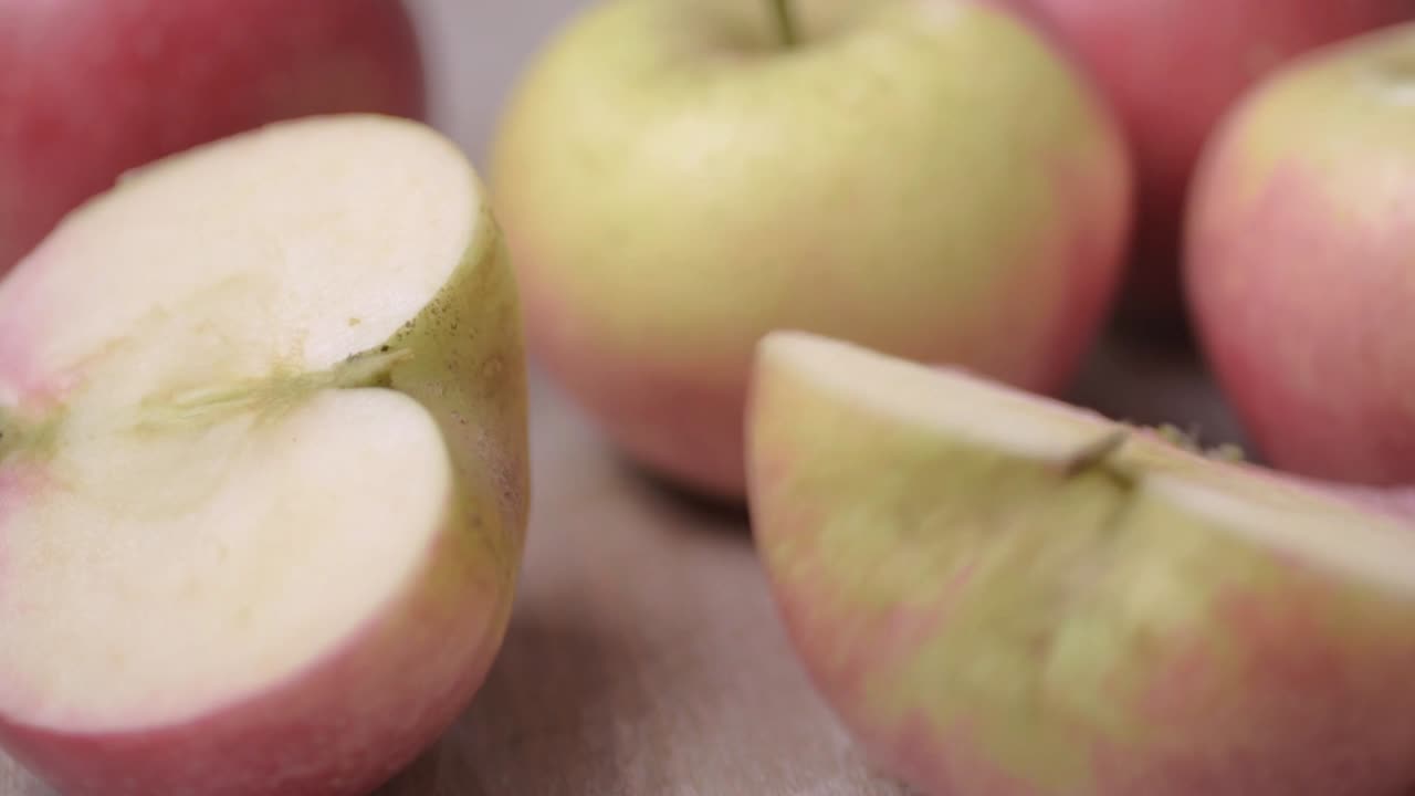 Group of fresh ripe red apples with sliced portions close up