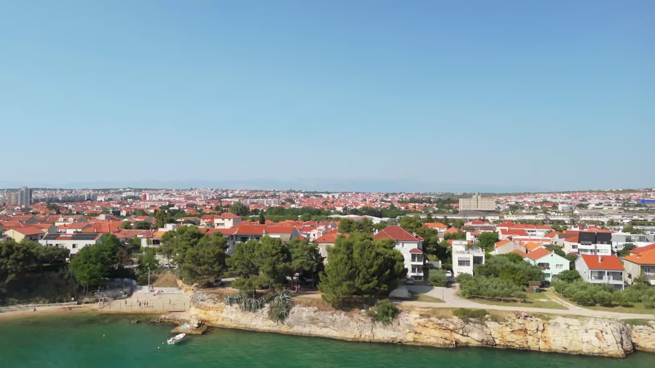 Zadar with drone an area of Punta Bajlo with sandy cliffs, green waters and red rooftops.