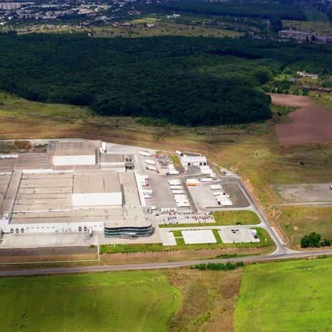 aerial view of a factory or industrial area surrounded by green fields. modern industrial factory