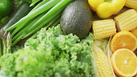 video of fresh fruit and vegetables over wooden background