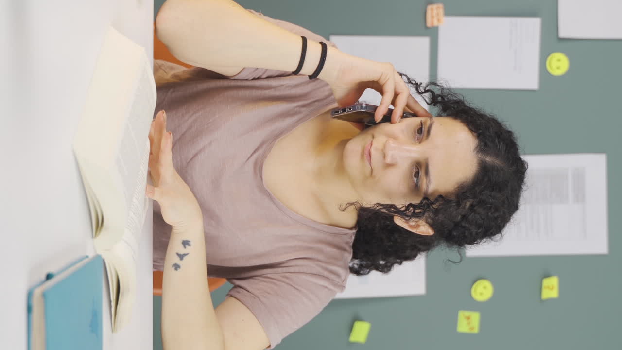 vídeo vertical de una estudiante recibiendo malas noticias por teléfono.
