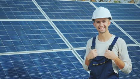 Portrait-Of-A-Worker-In-A-Hard-Hat-Looking-Into-The-Camera-Standing-On-The-Background-Of-A-Number-Of