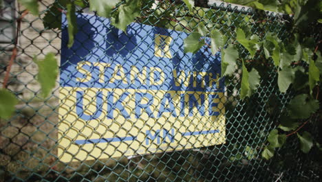 Stand-with-Ukraine-sign-on-fence-outside-of-house