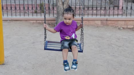 indian child having fun on swing in evening