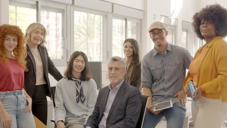coworking team and boss smiling at camera