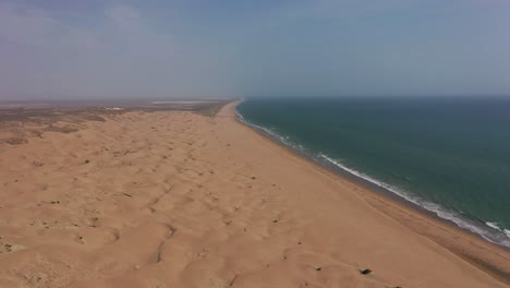 aerial slow rising over empty beach coastline at hingol national park in balochistan