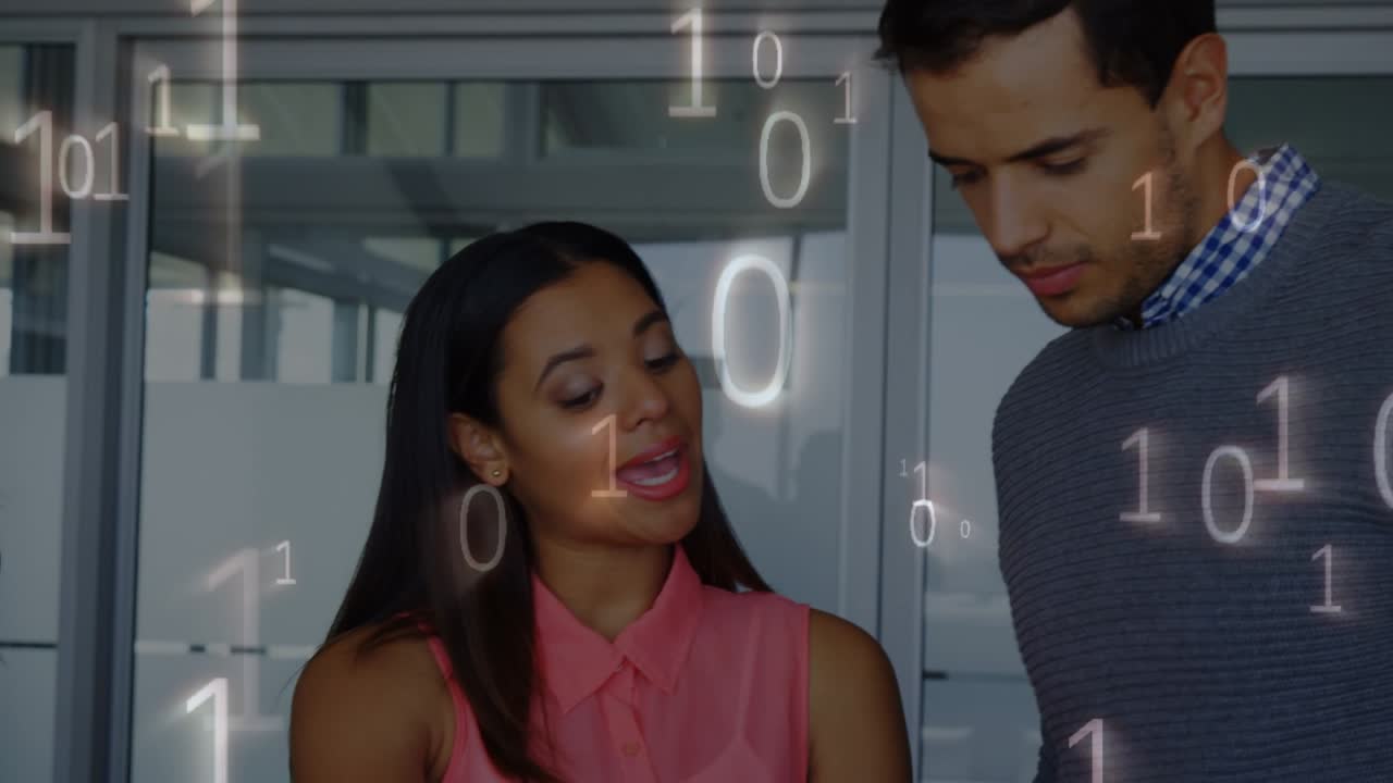 Animation of binary code over diverse female and male coworkers in office