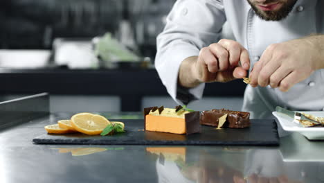 Chef-cooking-cake-at-workplace.-Closeup-male-hands-decorating-dessert