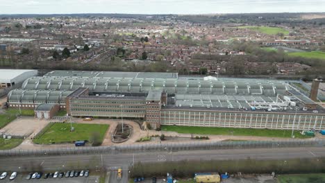 Royal-Mint-Printing-Works-in-Debden,-Essex-UK-slow-panning-drone-aerial