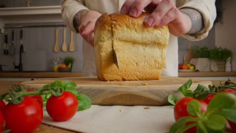 cutting a loaf of bread in the kitchen