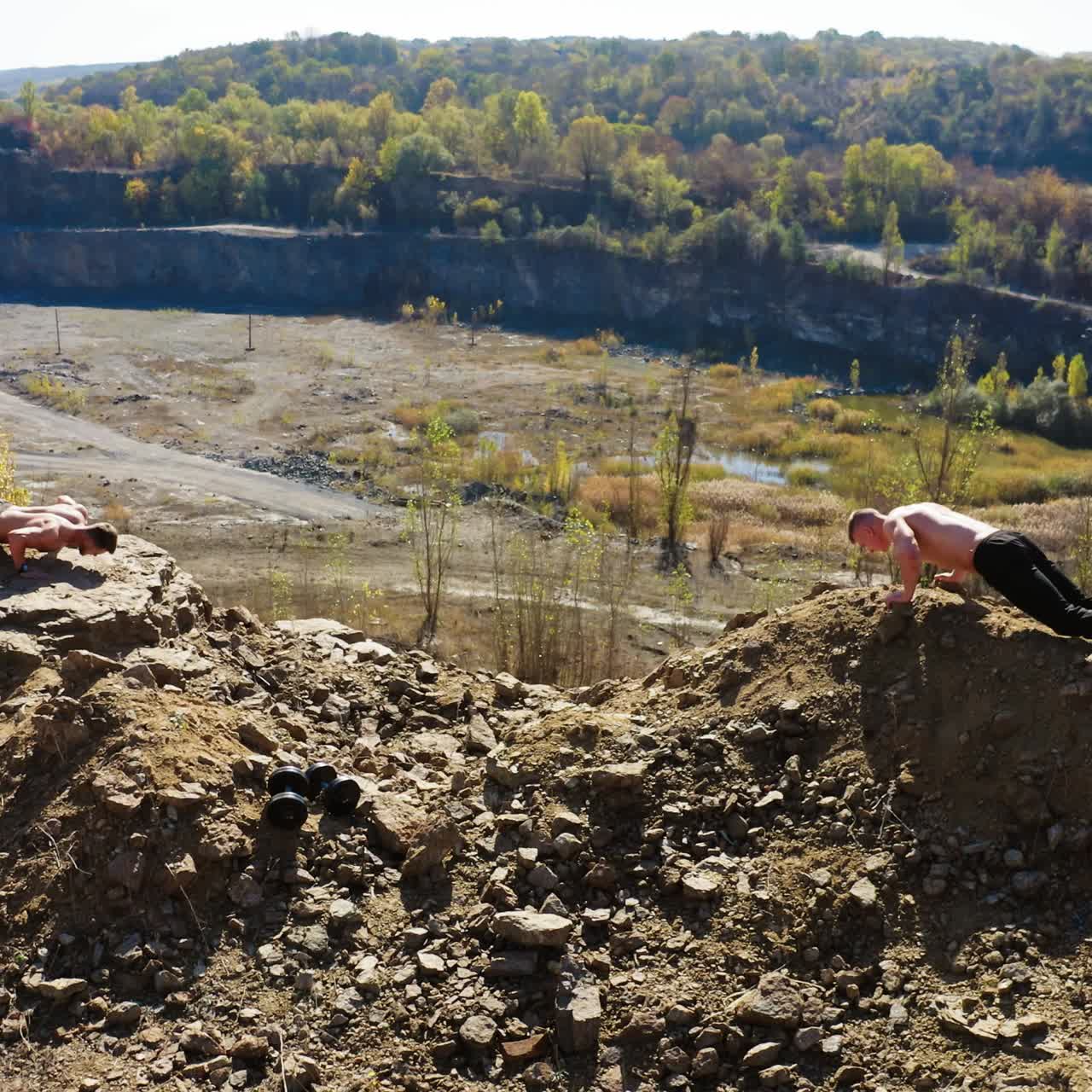 . Sportsmen doing push ups. Aerial view of young athletes doing push ups outdoors