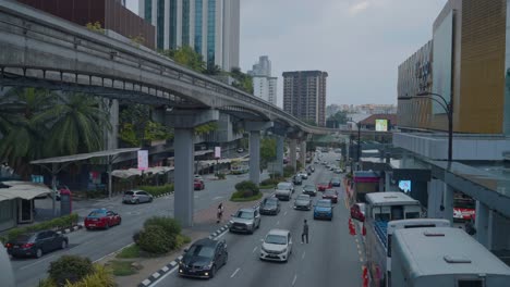 traffic congestion on a city street with monorail