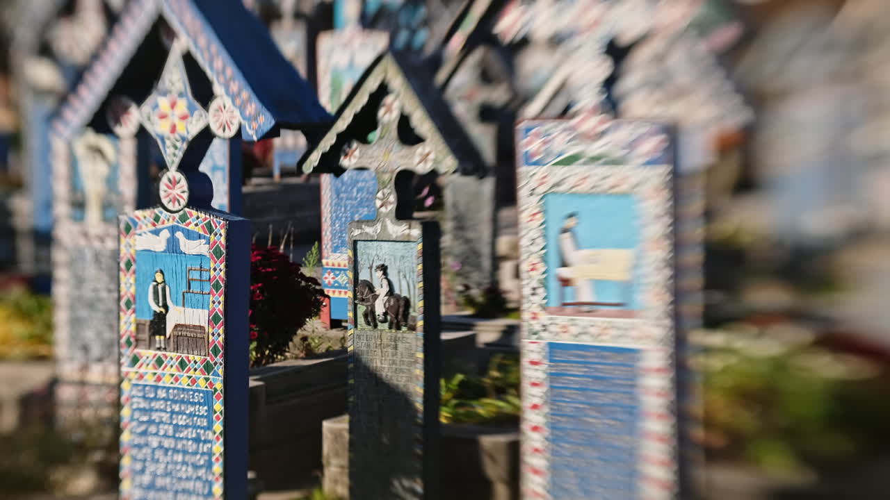 VISEU DE SUS, ROMANIA - OCTOBER 29, 2021: View of tombstones at the Merry Cemetery. Lensbaby effect