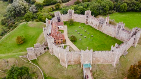 aerial: framlingham castle with nature surrounding at suffolk, england - drone tracking top shot