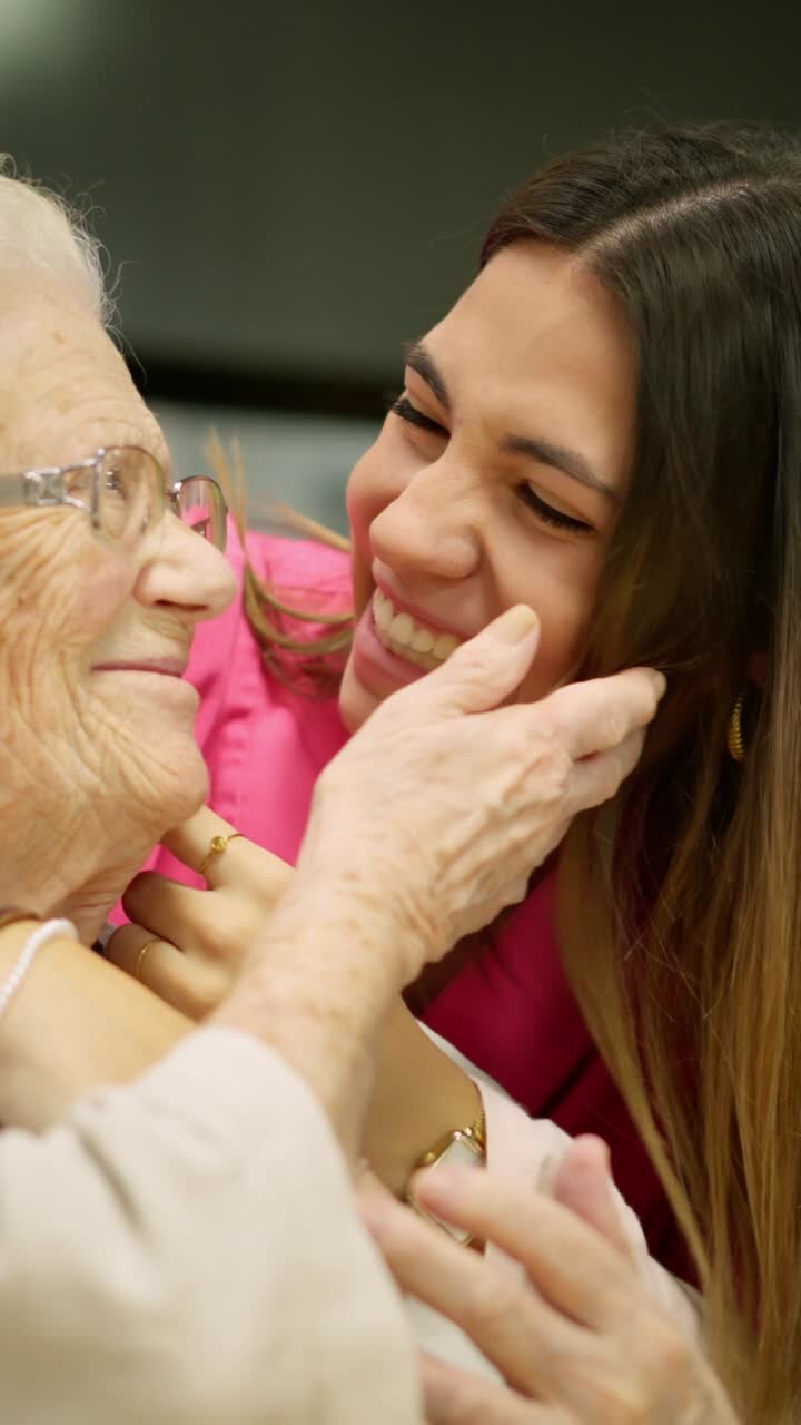 A touching moment between a young woman and an elderly woman