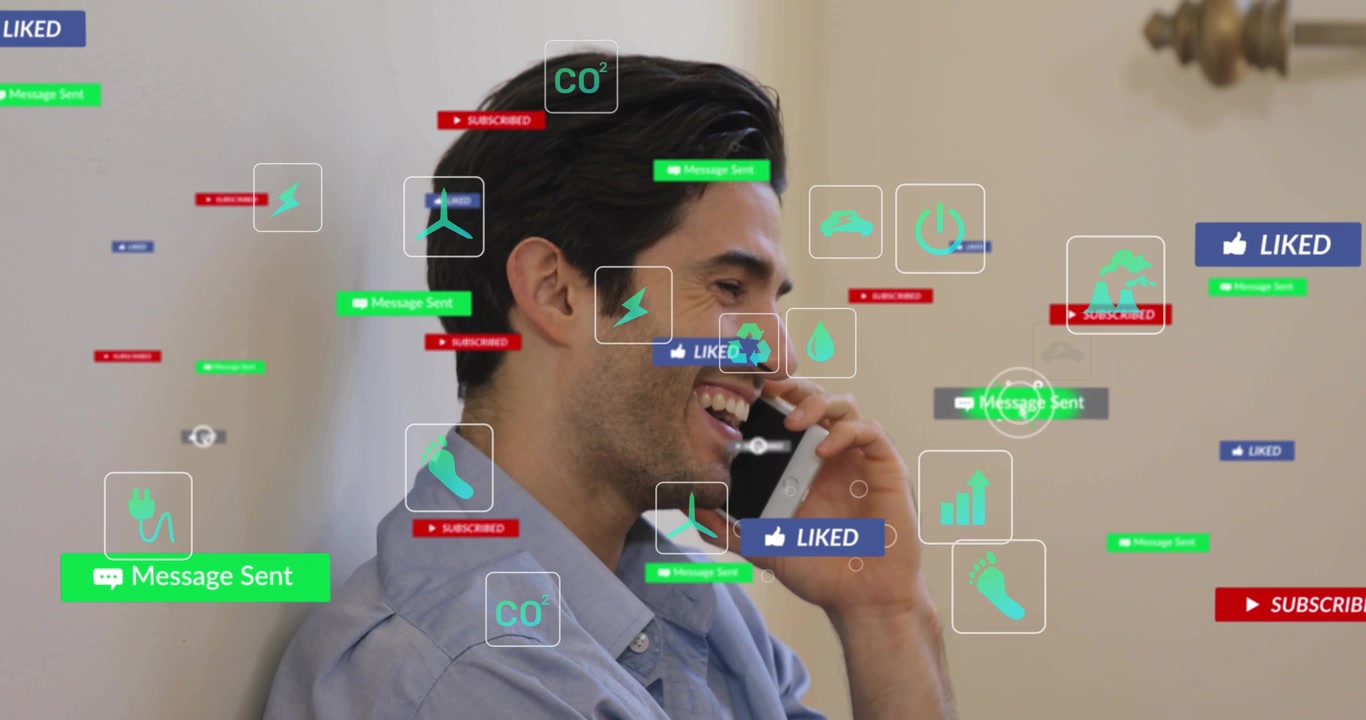 Vertical video: Getting icon flood, man laughing, holding phone to ear at home wearing blue shirt