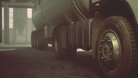 Heavy vehicle maneuvering through a quiet industrial area during morning light