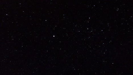 Panning-shot-across-multiple-shining-bright-stars-on-dark-black-sky.