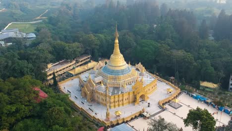 Aerial-of-Buddhist-temple-with-golden-pagoda-Lumbini-Natural-Park-or-Taman-Alam-Lumbini-in-Desa-Dolat-Rayat,-Berastagi-in-North-Sumatra,-Indonesia