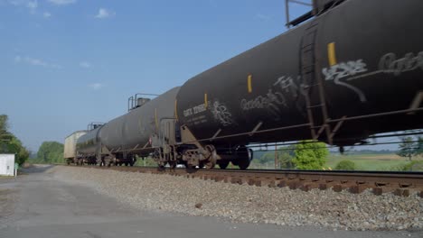 tren de mercancías con vagones cisterna en un cruce ferroviario