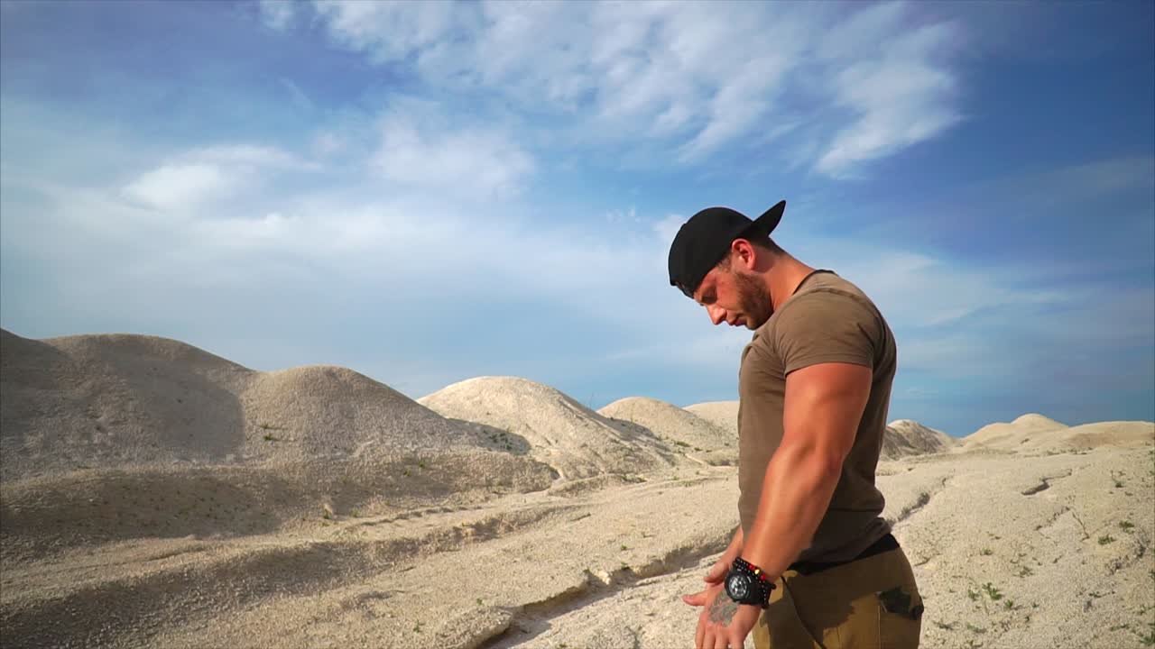 Man Posing and Stretching in a Desert Landscape