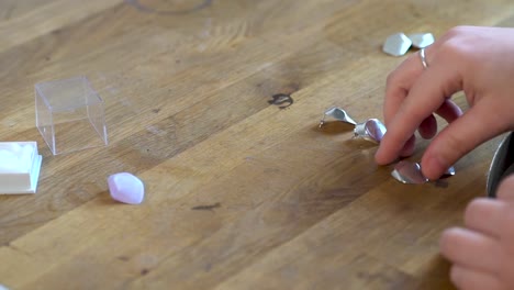 woman making silver earrings - handmade jewelry process