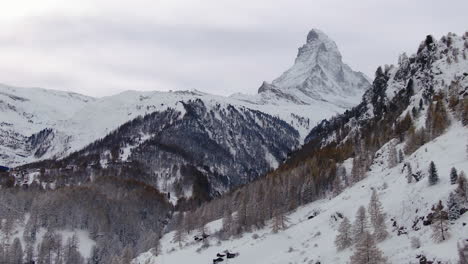 Opening-scenic-cinematic-aerial-drone-cabin-at-Zermatt-Switzerlands-most-famous-snow-cover-mountain-Matterhorn-October-November-heavy-fresh-snowfall-winter-on-climbing-peak-up-motion