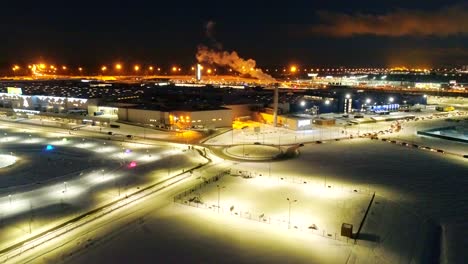 snowy park and junction by plant at winter night aerial view