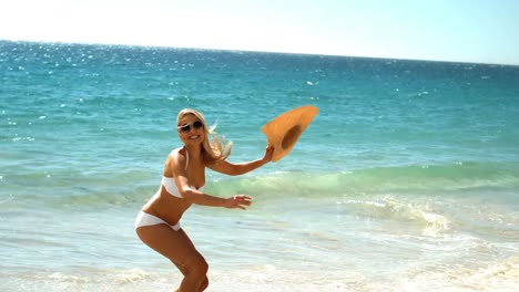 Young-woman-jumping-on-beach