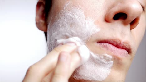 portrait of male model washing face with facial cleanser wash soap