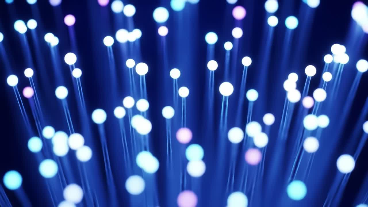 Illuminating blue and purple lights dance and pulse, showcasing the beauty of fiber optic cables. This display highlights the intricate interplay of technology and artistry in a dark space.