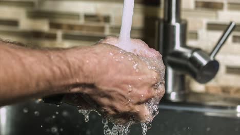 washing hands - person washing hands with running water - prevention for the spread of coronavirus pandemic (covid-19). - close up, slow motion