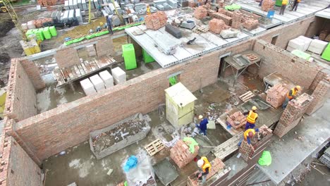 construction of the new building. vinnitsa, ukraine - june 2016: aerial shot of the professional construction worker laying bricks in industrial site