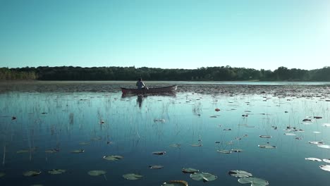 Ein-Mann,-Der-Friedlich-In-Seinem-Kanu-Auf-Dem-Pflaumensee-In-Minneola,-Florida,-Fischt