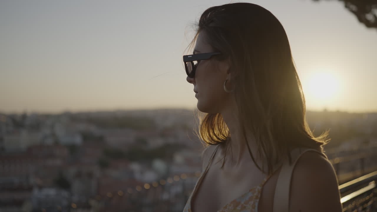 Woman enjoying a sunset view of the city