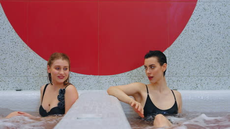 two women relaxing in a hot tub