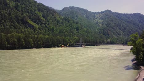 aerial flying over mountain river car bridge