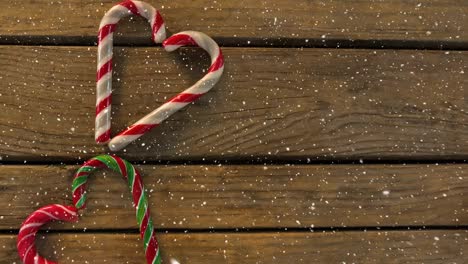 falling snow with christmas hearts decoration on wood