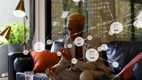 animation of network of connections over african american businessman talking on smartphone