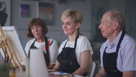 elderly men and women share their impressions of the drawing courses. emotions of a senior people talking together. activities for older friends