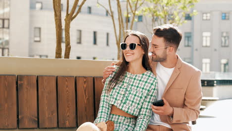 couple sitting on a bench in the city