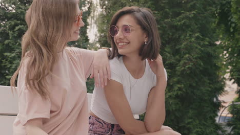 two women friends enjoying a moment together in a park