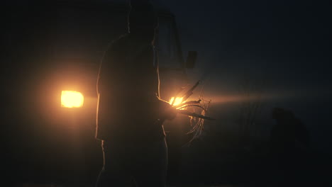 person walking at night with branches