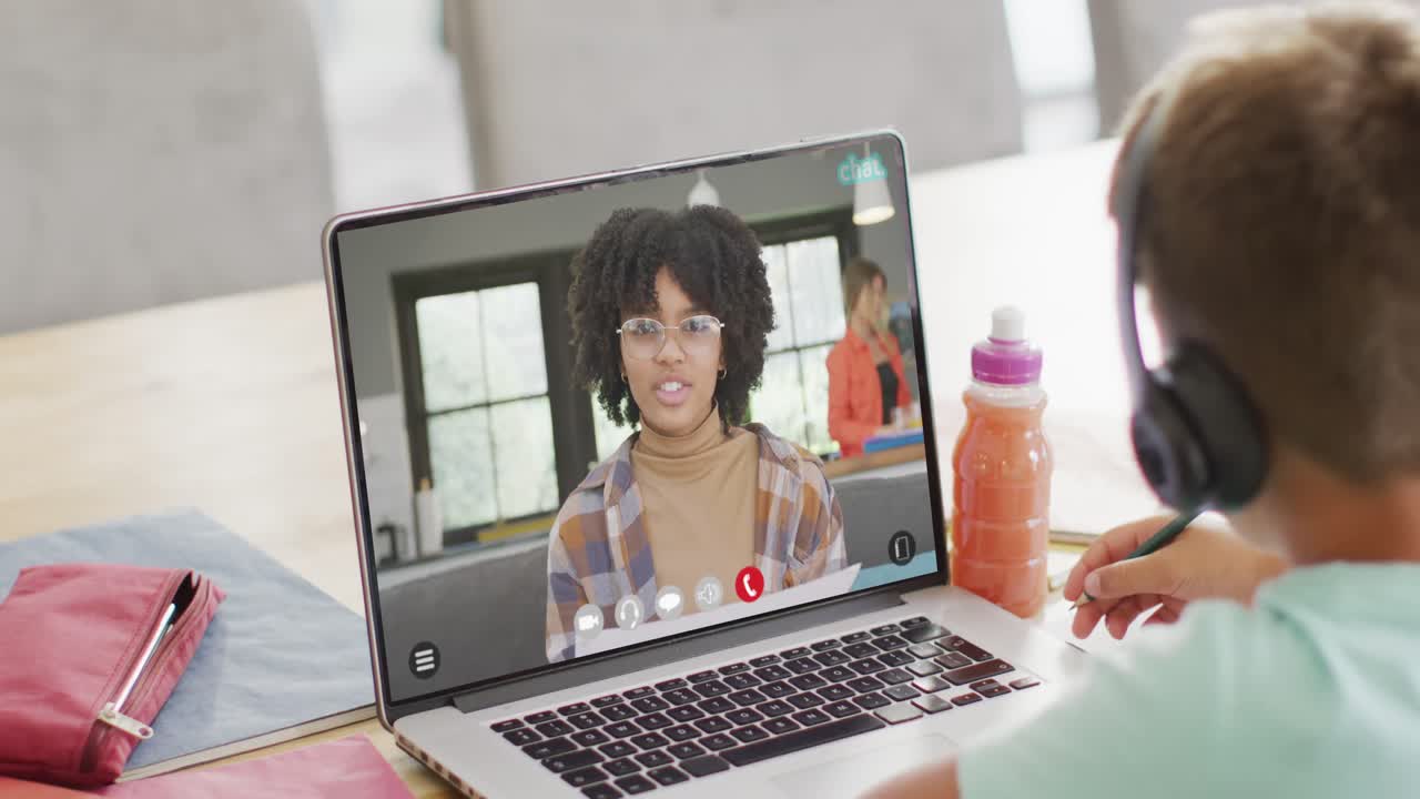 Composition of caucasian boy on laptop online learning with african american schoolgirl