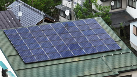 drone shot around of solar cells on a japanese house, cloudy day in japan