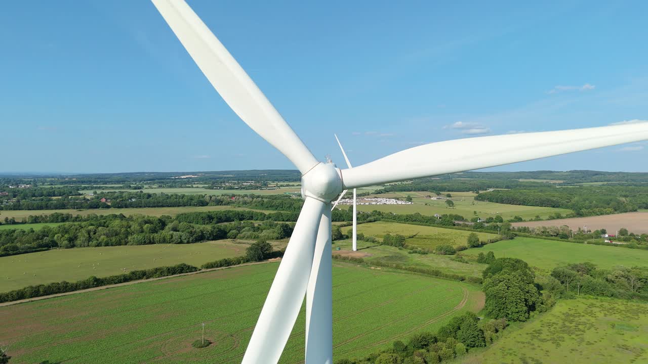 Aerial Drone View of Wind Turbines Generating Renewable Energy in Rural England at Sunset