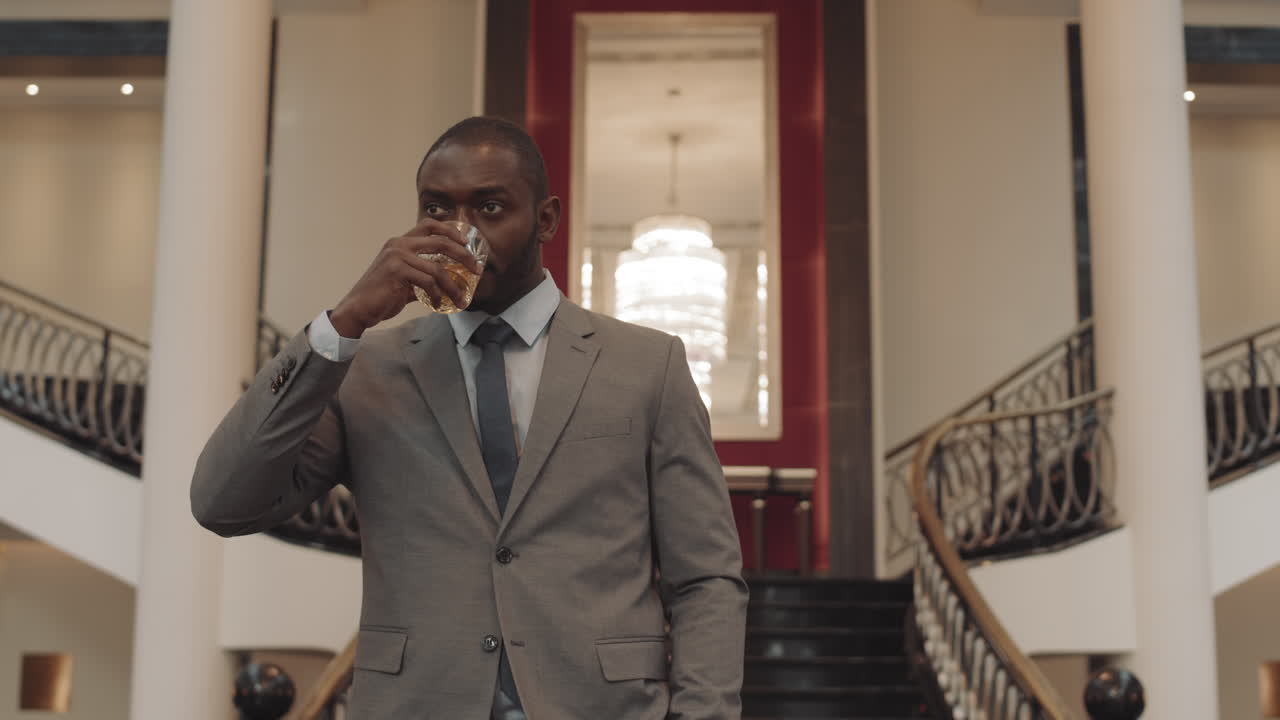 Successful Man with Whiskey Glass Walking