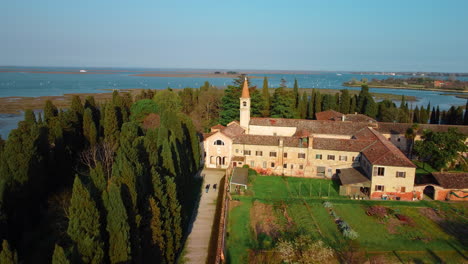 church and monastery of san francesco del deserto in venice. venice lagoon seen from above with drone. island of san francesco del deserto, burano, murano, torcello.