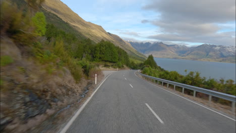 otago, new zealand - traveling on a road alongside lake wakatipu towards glenorchy - pov