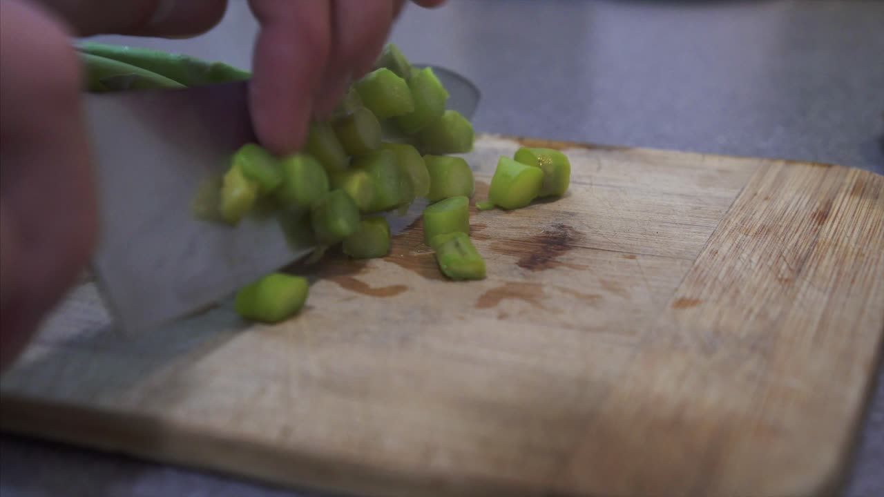 Chef preparing and Chopping Steamy Asparagus